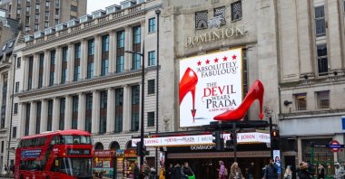 The Dominion Theater features an electronic billboard and a striking oversized red shoe promoting "The Devil Wears Prada" musical, London, U.K., Feb. 3, 2025. (Shutterstock Photo)