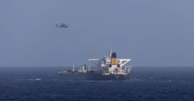 A U.S. military helicopter flies over the Panama-flagged Centuries, which was intercepted by the U.S. Coast Guard, east of Barbados in the Caribbean Sea, Dec. 20, 2025. (Reuters Photo)