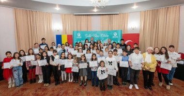 Students hold certificates after taking part in the 11th Traditional Turkish Poetry Recitation Contest organized by the Yunus Emre Institute in Constanța, Romania, Dec. 10, 2025. (AA Photo)
