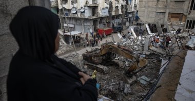A Palestinian woman watches rescue members remove the rubble of a home destroyed in Israeli airstrikes in Khan Younis, southern Gaza Strip, Palestine, Dec. 20, 2025. (EPA Photo)