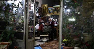 A Palestinian barber tends to a client in the old city of Nablus in the occupied West Bank, Dec. 20, 2025. (AFP Photo)