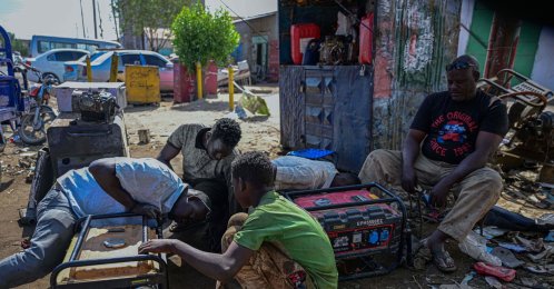 Sudanese men repair an electric generator at a workshop in the industrial area of Port Sudan, Dec. 19, 2025. (AFP Photo)