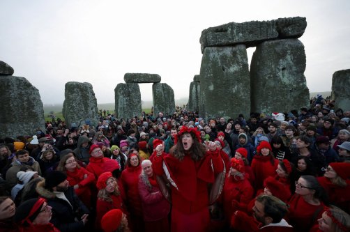 A choir performs as revelers attend winter solstice celebrations during sunrise at Stonehenge stone circle near Amesbury, Britain, Dec. 21, 2025. (Reuters Photo)