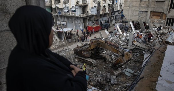 A Palestinian woman watches rescue members remove the rubble of a home destroyed in Israeli airstrikes in Khan Younis, southern Gaza Strip, Palestine, Dec. 20, 2025. (EPA Photo)