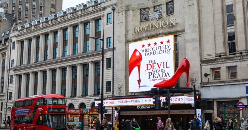 The Dominion Theater features an electronic billboard and a striking oversized red shoe promoting "The Devil Wears Prada" musical, London, U.K., Feb. 3, 2025. (Shutterstock Photo)