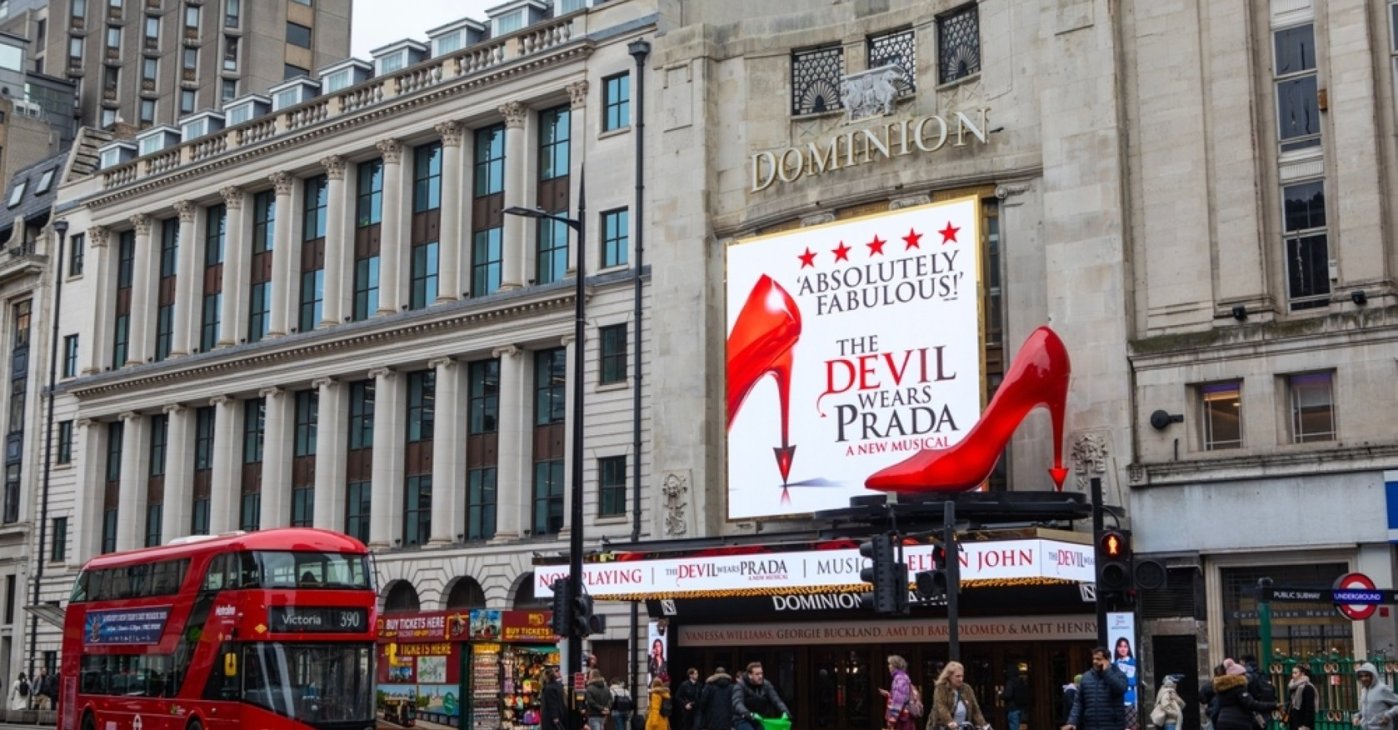 The Dominion Theater features an electronic billboard and a striking oversized red shoe promoting "The Devil Wears Prada" musical, London, U.K., Feb. 3, 2025. (Shutterstock Photo)