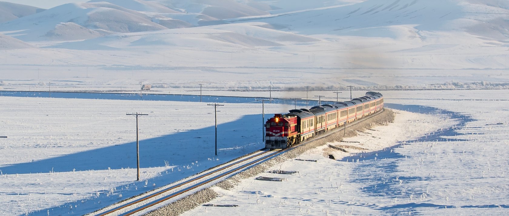 The Touristic Eastern Express travels along snow-covered tracks near Kars, eastern Türkiye, Jan. 20, 2020. (Shutterstock Photo)