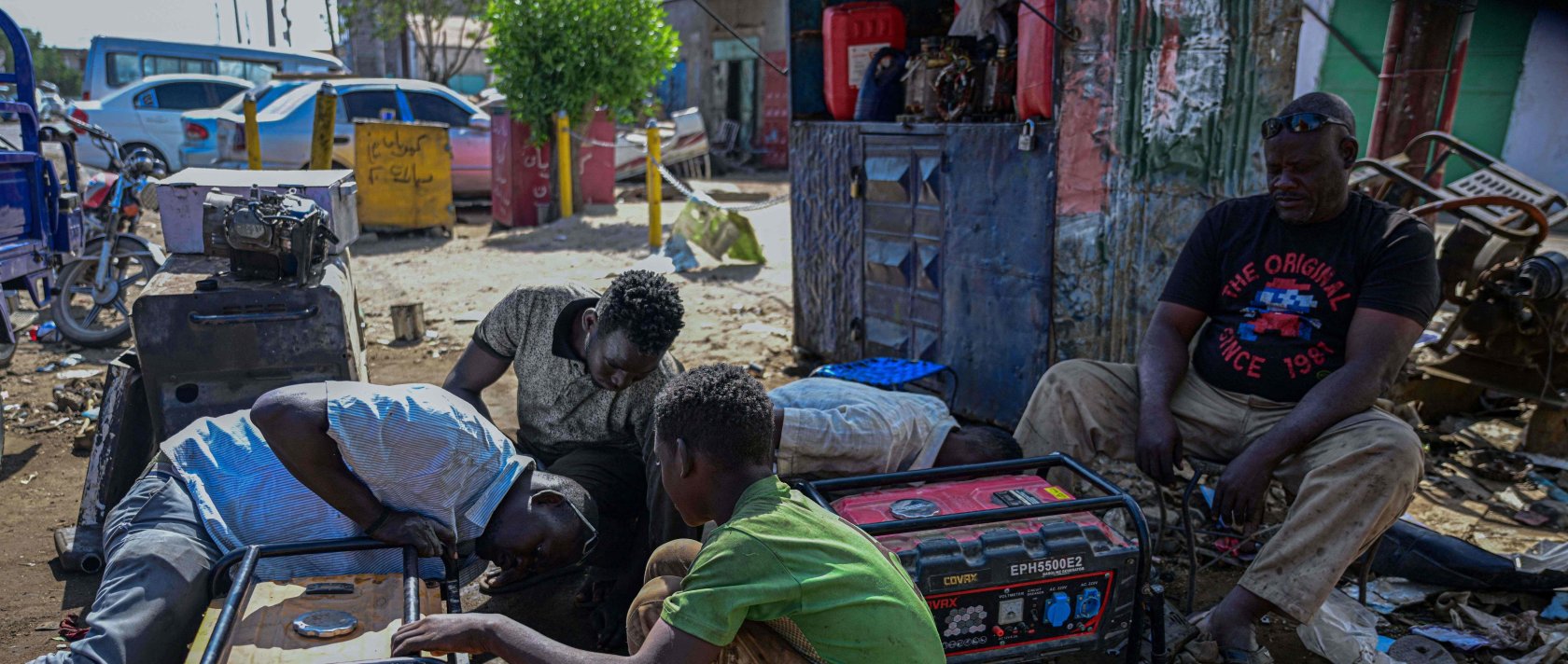 Sudanese men repair an electric generator at a workshop in the industrial area of Port Sudan, Dec. 19, 2025. (AFP Photo)