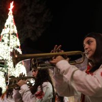 A scout's band plays as residents gather near a lit Christmas tree as they prepare for the upcoming Christmas festivities in the mainly Christian village of al-Qanayyah, Idlib, Syria, Dec. 20, 2025. (AFP Photo)