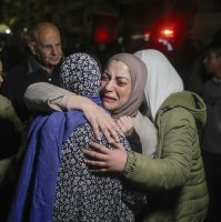 A female Palestinian prisoner, facing the camera, is greeted after disembarking from a bus following her release from an Israeli prison, in the West Bank city of Beitunia, Jan. 20, 2025. (AP Photo)