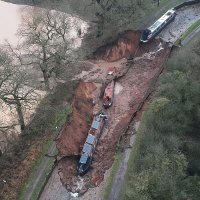 This handout aerial photo taken and released by the Shropshire Fire and Rescue Service shows boats on the bed of the canal after a sinkhole developed along the Shropshire Union Canal, draining the water, in the Chemistry area of Whitchurch, Shropshire, central England, Dec. 22, 2025. (AFP Photo)