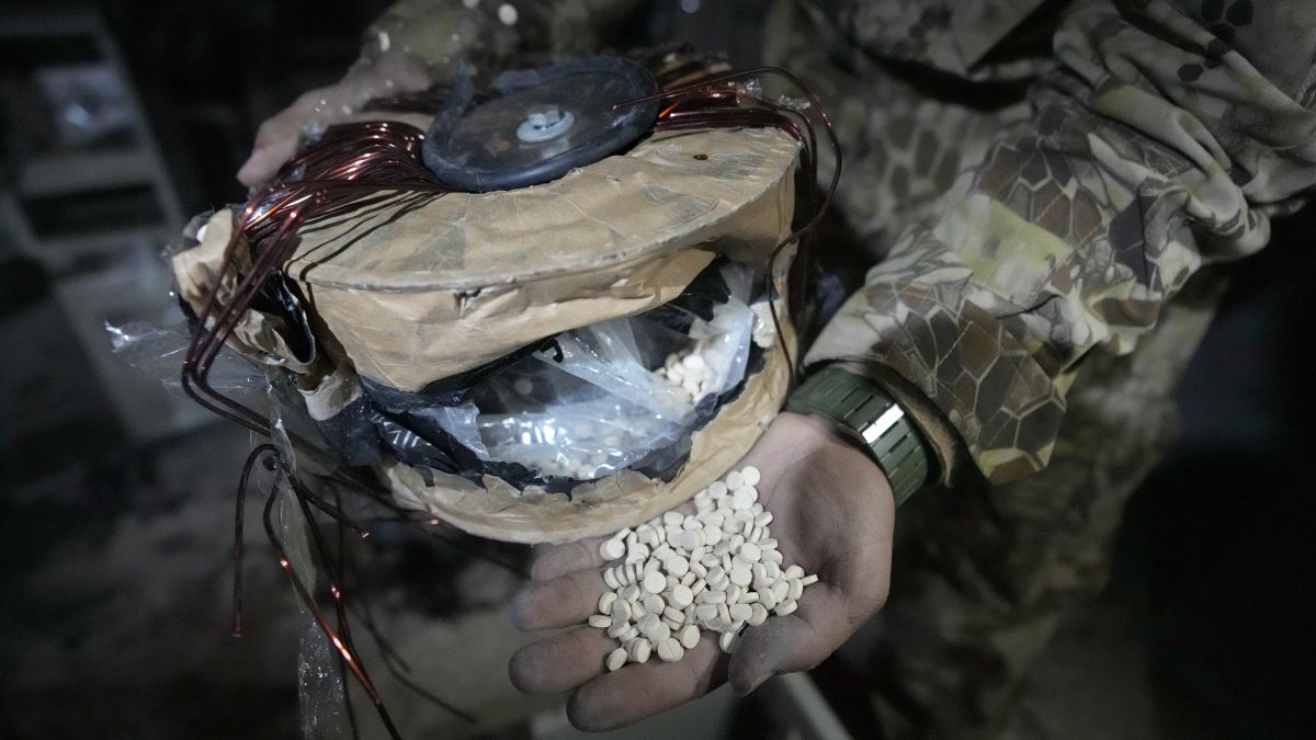 A Syrian member of the anti-regime alliance shows amphetamine pills known as Captagon hidden inside an electrical component at a warehouse, in Douma city, outskirts of Damascus, Syria, Dec. 13, 2024. (AP Photo)