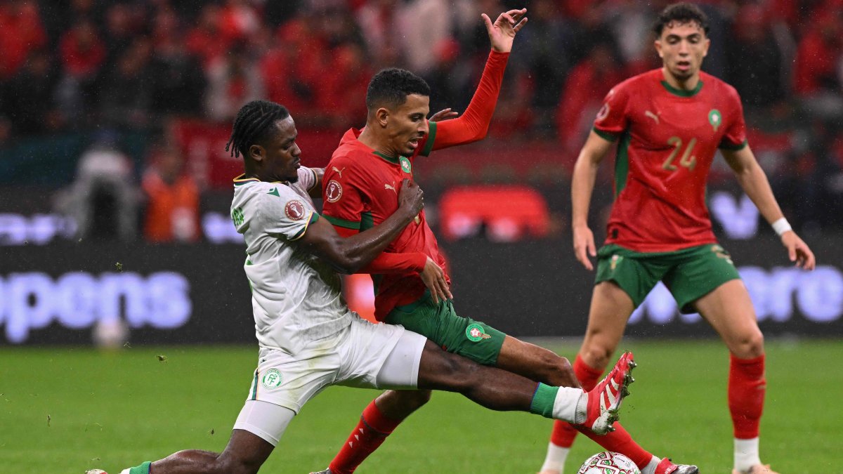 Comoros' Ismael Boura (L) fights for the ball with Morocco's Azzedine Ounahi during the Africa Cup of Nations (CAN) group A  football match at Prince Moulay Abdellah Stadium, Rabat, Morocco, Dec. 21, 2025. (AFP Photo)