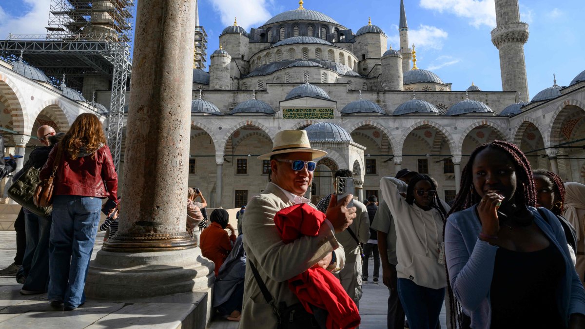 Tourists visit Sultanahmet Mosque, also known as the Blue Mosque, Istanbul, Türkiye, Nov. 24, 2025. (AFP Photo)
