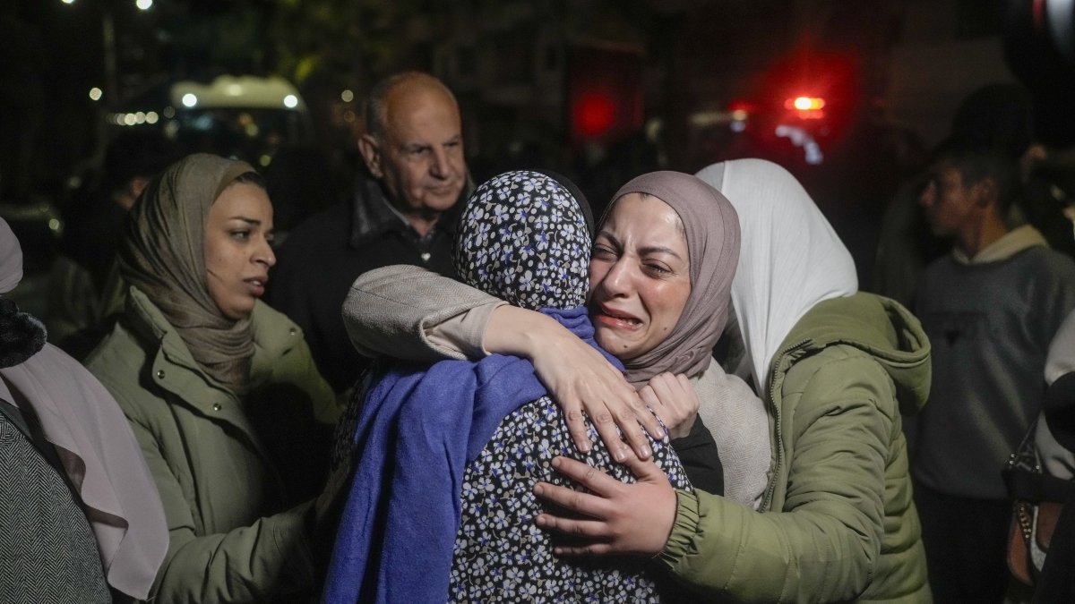 A female Palestinian prisoner, facing the camera, is greeted after disembarking from a bus following her release from an Israeli prison, in the West Bank city of Beitunia, Jan. 20, 2025. (AP Photo)