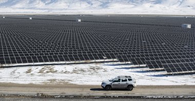 Technicians drive a car past photovoltaic panels at the Kalyon PV Karapınar Solar Power Plant, Konya, central Türkiye, Feb. 2, 2023. (EPA Photo)