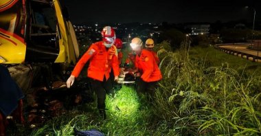 Rescuers transfer an injured passenger after a bus crash in Semarang, central Java, Indonesia, Dec. 22, 2025. (DHA Photo)