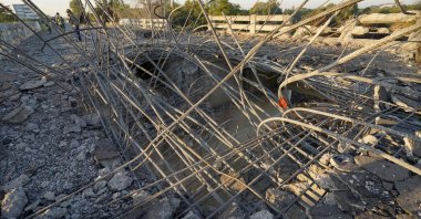 A man looks at a damaged bridge after Thailand carried out airstrikes in an area near Oddar Meanchey, Cambodia, Dec. 20, 2025. (AFP Photo)