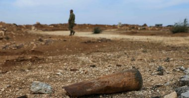 A soldier from the Syrian Defense Ministry walks near an exploded shell casing near an abandoned military base, on the southern outskirts of Aleppo, Dec. 4, 2025. (AFP Photo)
