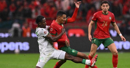 Comoros' Ismael Boura (L) fights for the ball with Morocco's Azzedine Ounahi during the Africa Cup of Nations (CAN) group A  football match at Prince Moulay Abdellah Stadium, Rabat, Morocco, Dec. 21, 2025. (AFP Photo)
