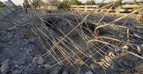 A man looks at a damaged bridge after Thailand carried out airstrikes in an area near Oddar Meanchey, Cambodia, Dec. 20, 2025. (AFP Photo)
