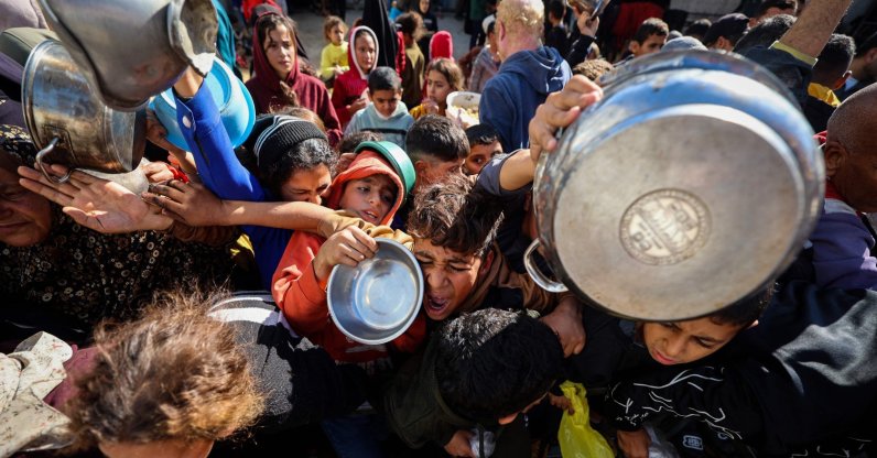 A boy reacts as displaced Palestinians gather to receive food portions at a charity kitchen in the Nuseirat refugee camp in the central Gaza Strip, Dec. 20, 2025. (AFP Photo)
