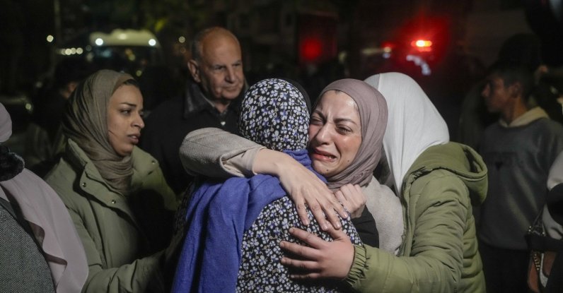 A female Palestinian prisoner, facing the camera, is greeted after disembarking from a bus following her release from an Israeli prison, in the West Bank city of Beitunia, Jan. 20, 2025. (AP Photo)