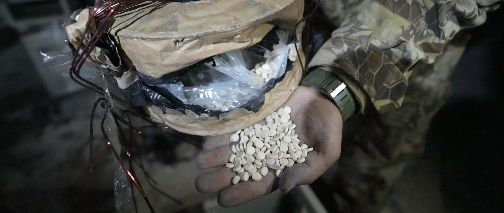 A Syrian member of the anti-regime alliance shows amphetamine pills known as Captagon hidden inside an electrical component at a warehouse, in Douma city, outskirts of Damascus, Syria, Dec. 13, 2024. (AP Photo)