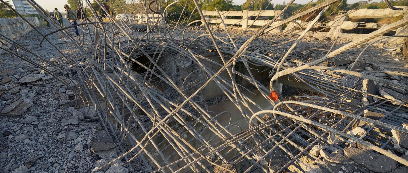 A man looks at a damaged bridge after Thailand carried out airstrikes in an area near Oddar Meanchey, Cambodia, Dec. 20, 2025. (AFP Photo)