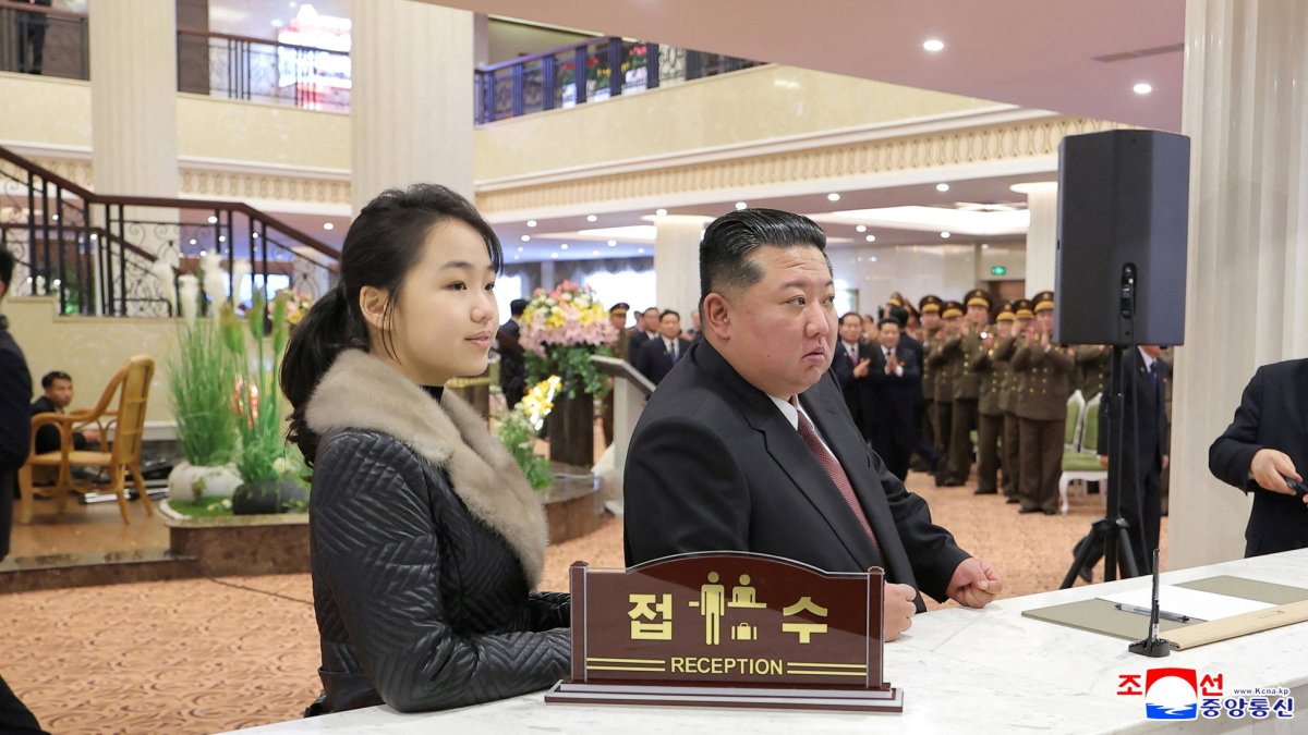 North Korean leader Kim Jong Un and his daughter Kim Ju Ae stand at a hotel reception counter as they attend an inauguration ceremony for hotels in the tourist resort, Samjiyon, North Korea, Dec. 20, 2025. (Reuters Photo)