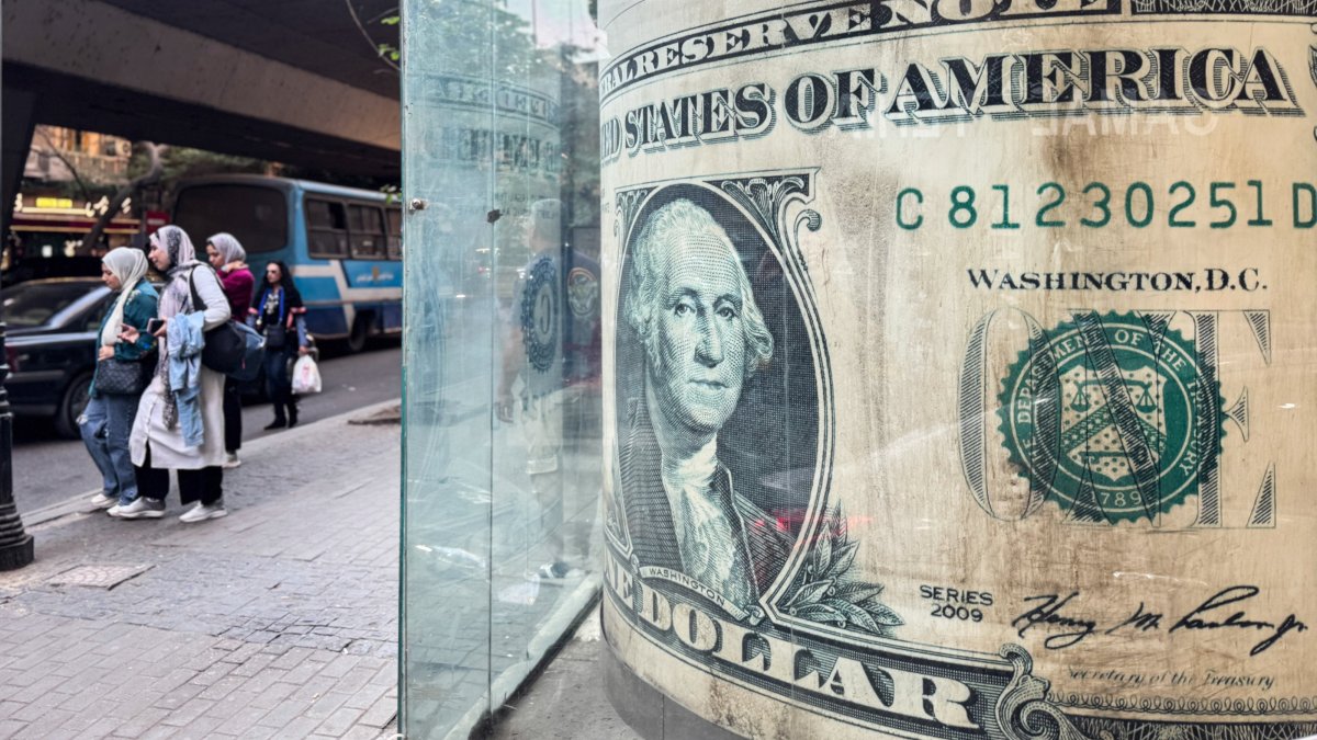 People walk past a currency exchange office in Cairo, Egypt, Dec. 2, 2025. (EPA Photo)
