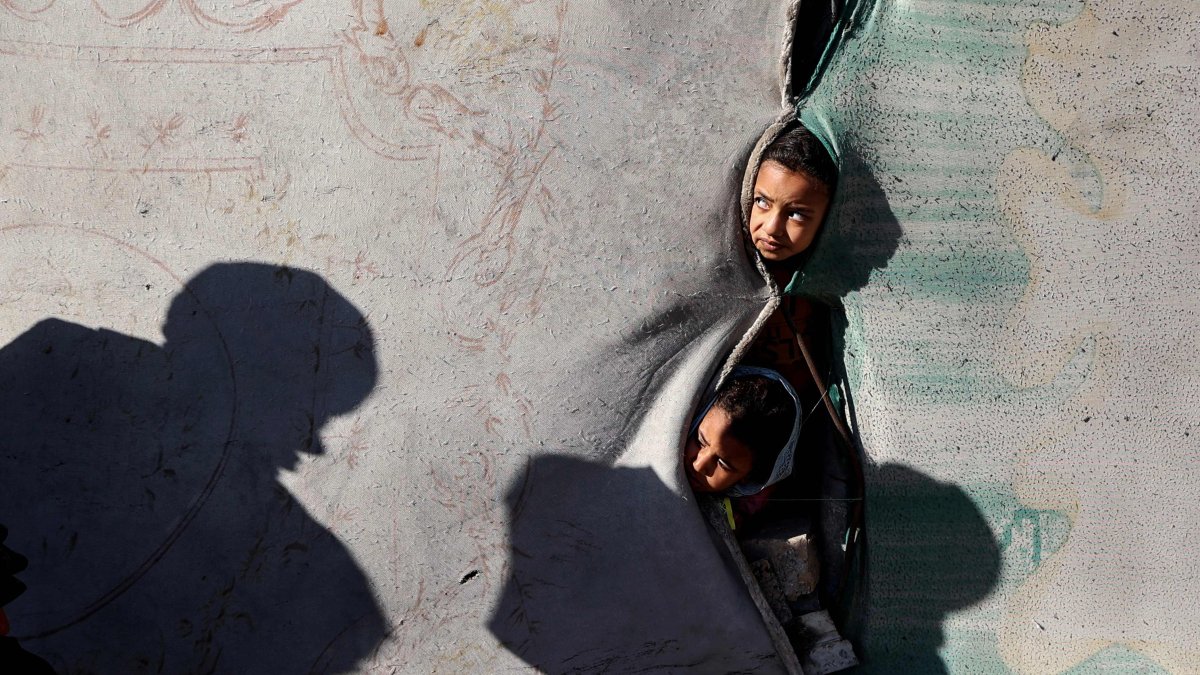 Children look on from a shelter in the Nuseirat camp for displaced Palestinians in the central Gaza Strip, Palestine, Dec. 22, 2025. (AFP Photo)