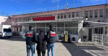 Gendarmerie officers escort a Daesh terrorist group fugitive who was arrested during a dawn operation in Gaziantep, Türkiye, Dec. 21, 2025. (IHA Photo)