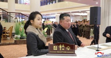 North Korean leader Kim Jong Un and his daughter Kim Ju Ae stand at a hotel reception counter as they attend an inauguration ceremony for hotels in the tourist resort, Samjiyon, North Korea, Dec. 20, 2025. (Reuters Photo)