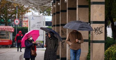 Residents use umbrellas as heavy rain affects the Konak district, Izmir, Türkiye, Dec. 5, 2025. (AA Photo)