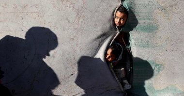 Children look on from a shelter in the Nuseirat camp for displaced Palestinians in the central Gaza Strip, Palestine, Dec. 22, 2025. (AFP Photo)