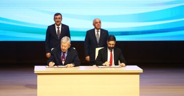 Vice President Cevdet Yılmaz and Azerbaijan's Prime Minister Ali Asadov oversee a signing ceremony for a gas plant between SOCAR and Gama Enerji during the Azerbaijan-Türkiye Investment Forum, Baku, Azerbaijan, Dec. 23, 2025. (AA Photo)