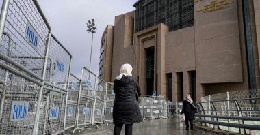The mother of Ibtissem B waits outside Çağlayan Courthouse, in Istanbul, Dec. 23, 2025. (AFP Photo)