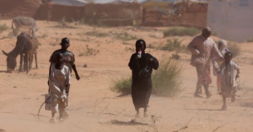 Sudanese refugees from Darfur walk amidst a sandstorm at the Touloum refugee camp, in Wadi Fira province, Chad, Nov. 30, 2025. (Reuters Photo)