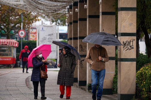 Residents use umbrellas as heavy rain affects the Konak district, Izmir, Türkiye, Dec. 5, 2025. (AA Photo)