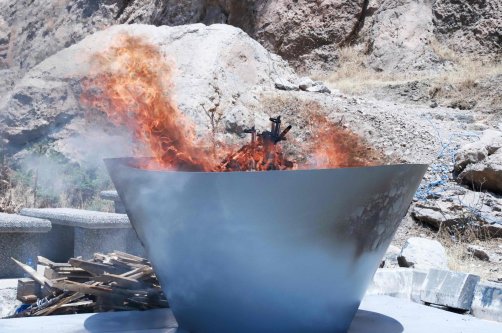 A pit filled with weapons is set on fire by the PKK during a ceremony, Sulaimaniyah, Iraq, July 11, 2025. (AFP Photo)