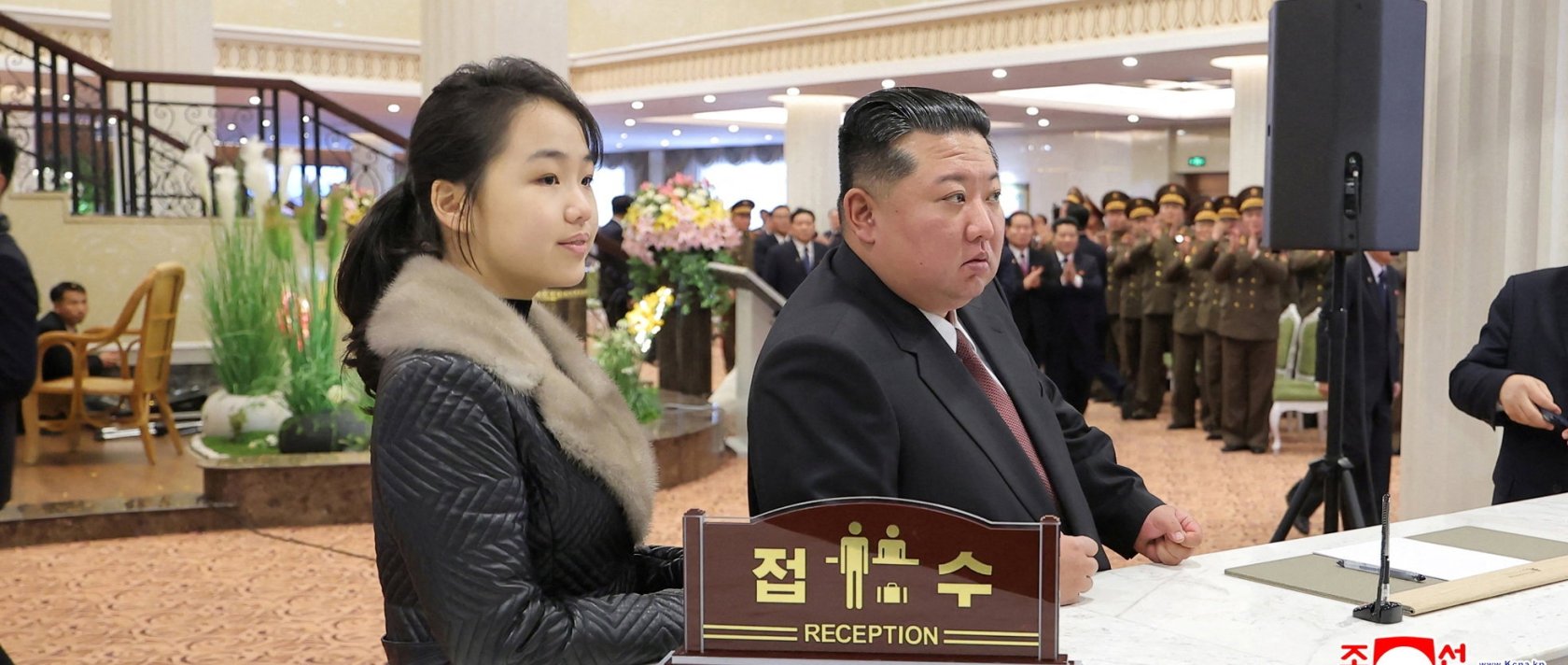 North Korean leader Kim Jong Un and his daughter Kim Ju Ae stand at a hotel reception counter as they attend an inauguration ceremony for hotels in the tourist resort, Samjiyon, North Korea, Dec. 20, 2025. (Reuters Photo)
