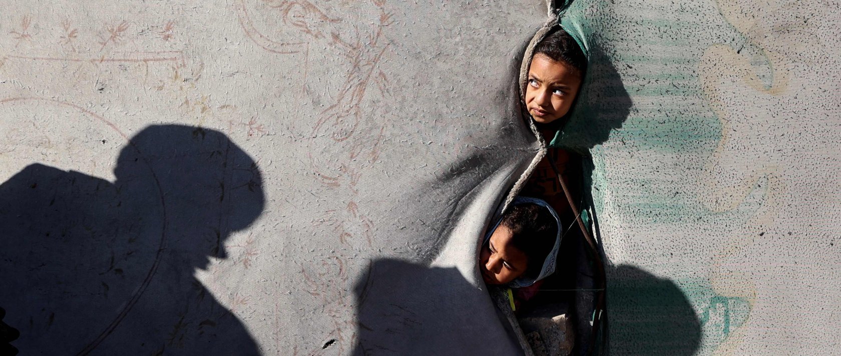 Children look on from a shelter in the Nuseirat camp for displaced Palestinians in the central Gaza Strip, Palestine, Dec. 22, 2025. (AFP Photo)