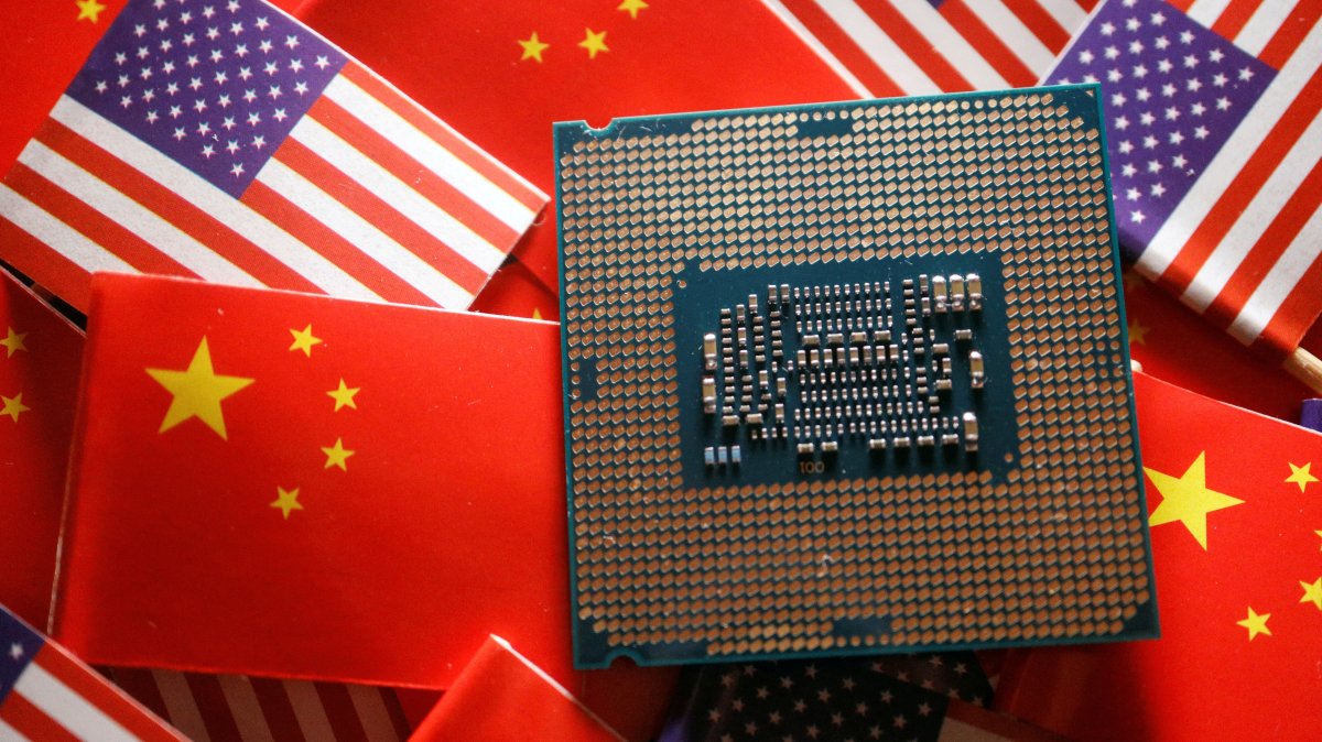 A central processing unit semiconductor chip is displayed among flags of China and the U.S., Feb. 17, 2023. (Reuters Photo)