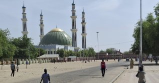 People walk past a mosque in Maiduguri, Nigeria, March 14, 2025. (AP Photo)