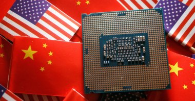 A central processing unit semiconductor chip is displayed among flags of China and the U.S., Feb. 17, 2023. (Reuters Photo)