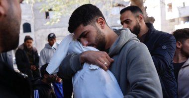 A Palestinian man carries the body of his 5-month-old brother, Ahmed Al-Nader, who was reportedly killed the previous day along with other family members in an Israeli shelling on a school-turned-shelter, ahead of his funeral in the Tuffah neighbourhood of Gaza City, Dec. 20, 2025. (AFP Photo)