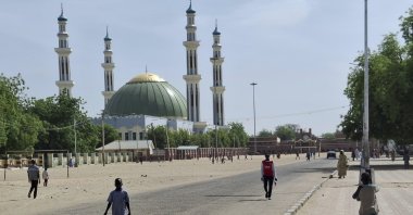 People walk past a mosque in Maiduguri, Nigeria, March 14, 2025. (AP Photo)