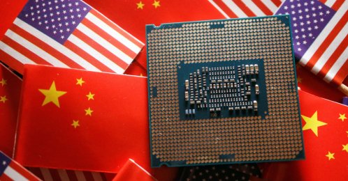 A central processing unit semiconductor chip is displayed among flags of China and the U.S., Feb. 17, 2023. (Reuters Photo)