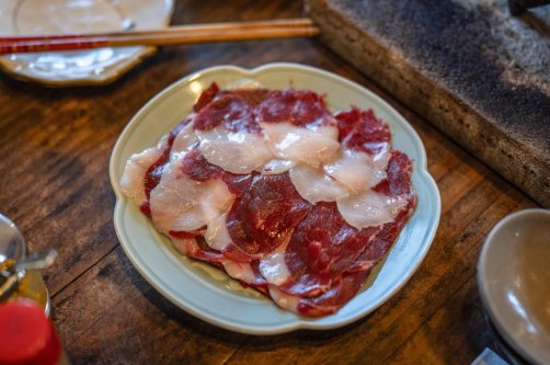 In this picture, slices of bear meat are served on a plate at a restaurant in Chichibu, Saitama Prefecture, Japan, Dec. 12, 2025. (AFP Photo)